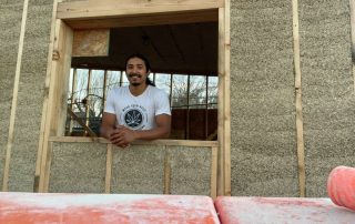 Amos Lozano standing in the midst of his hempcrete-build cannabis juice shop.