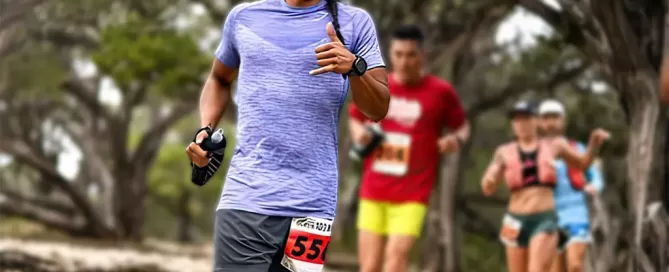 Amos Lozano running on a outdoor trail in a race.